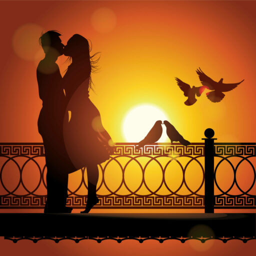 A silhouette of a couple kissing with the sunset in the background